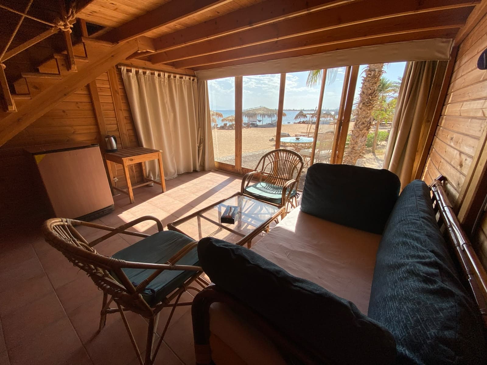 Ground floor lounge with glass doors facing beach